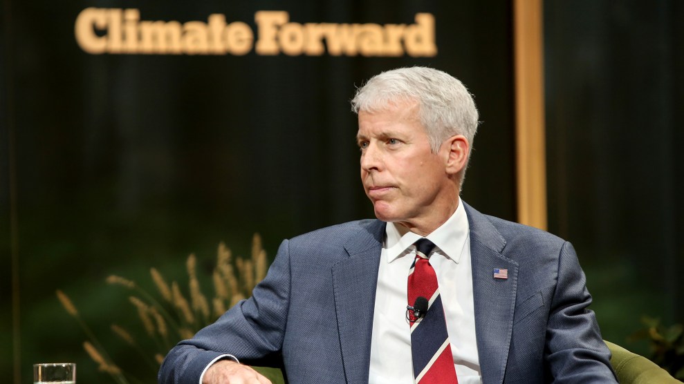 Chris Wright sits in front of a sign that says "Climate Forward."
