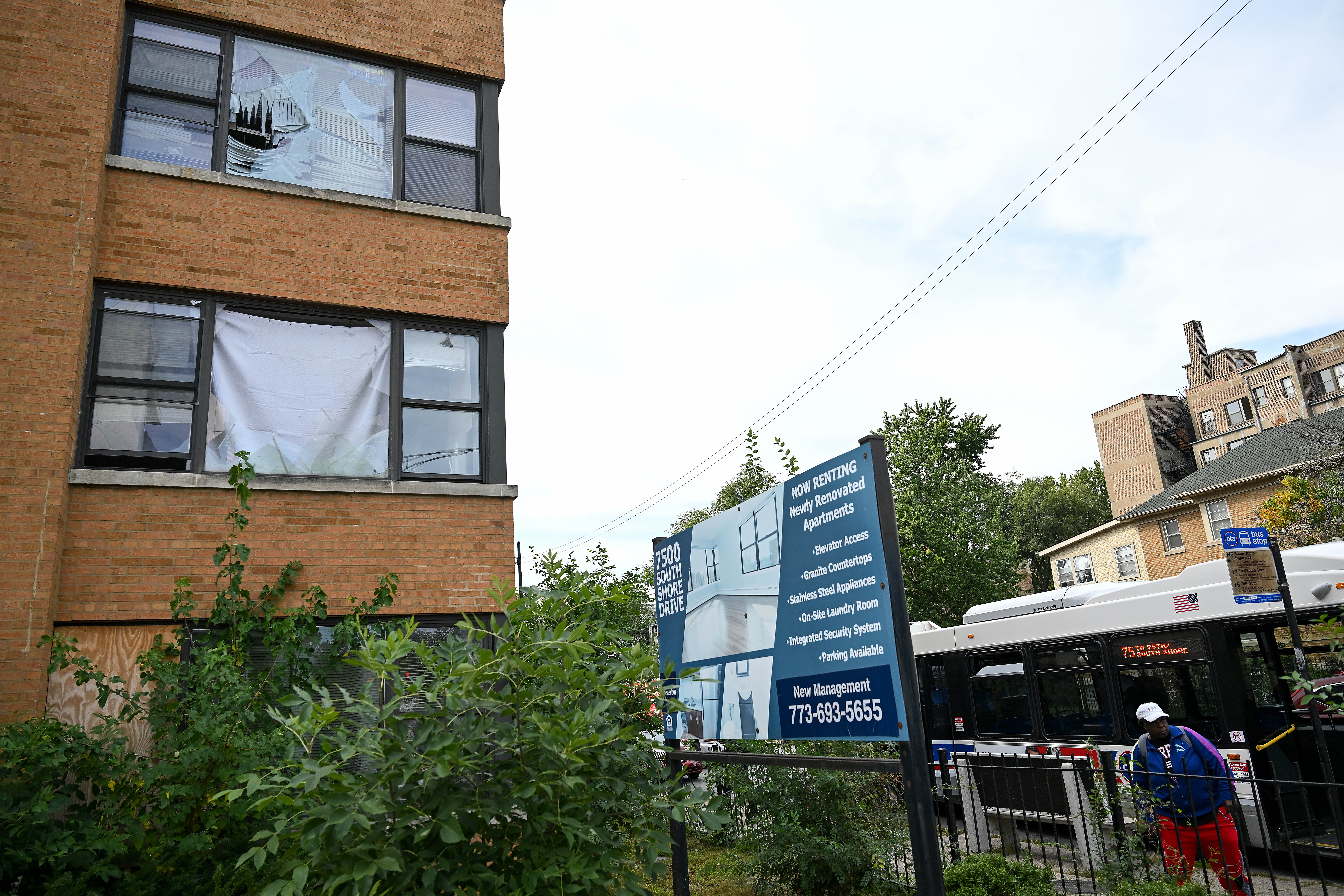 Outside of an apartment complex, showing a broken windown.