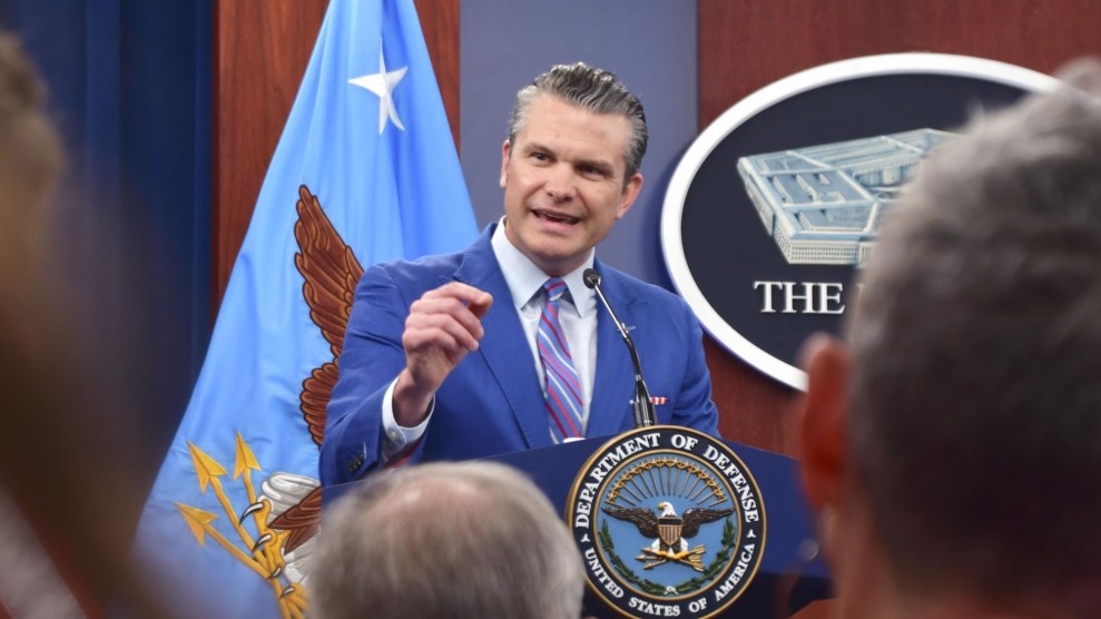 Pete Hegseth speaks from behind a podium in the Pentagon briefing room.