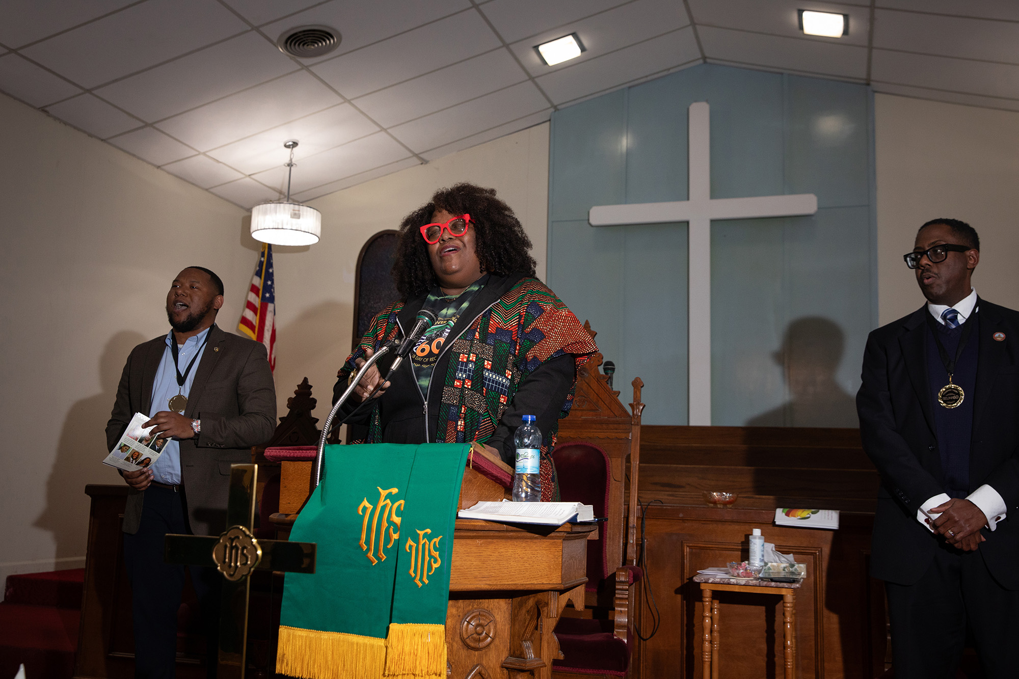 African American woman speaks at a church pulpit.