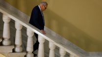 Sen. Chuck Schumer walking down a flight of stairs at the Capitol Building.