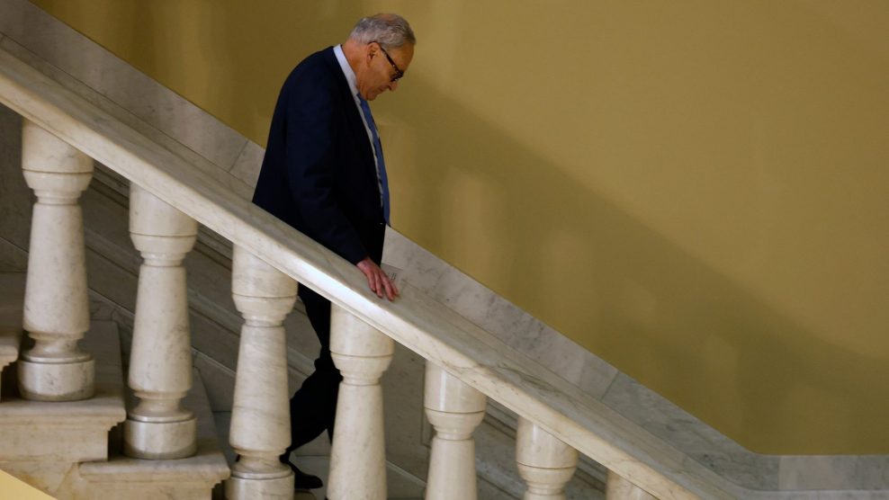Sen. Chuck Schumer walking down a flight of stairs at the Capitol Building.