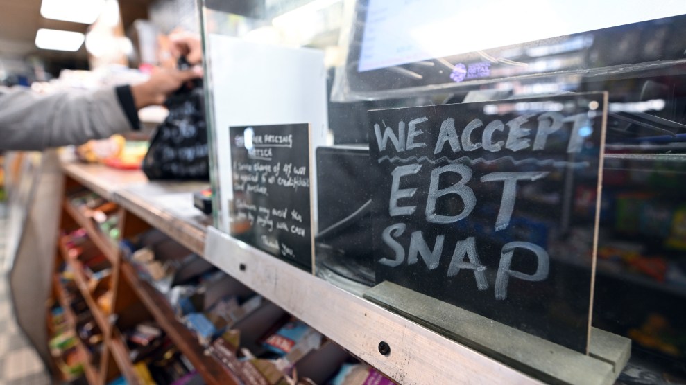 A sign in front of a cash register reads "We accept EBT SNAP"