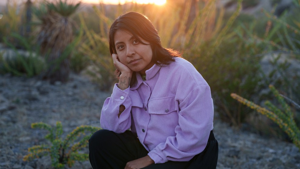 Portrait of woman kneeling in the desert.