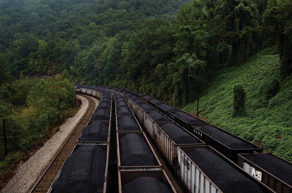 Coal piles on railroad cars.