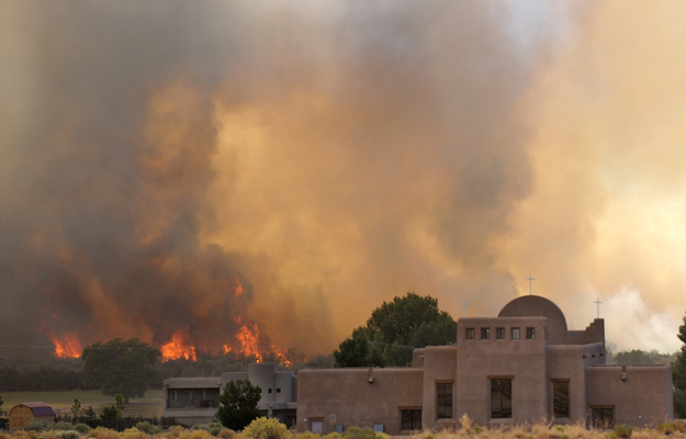 June 20, 2012 - A wildfire blazes behind St. Anthony Catholic Church in Sandia Pueblo, N. Mex.  Jim Thompson/Albuquerque Journal/ZUMAPress