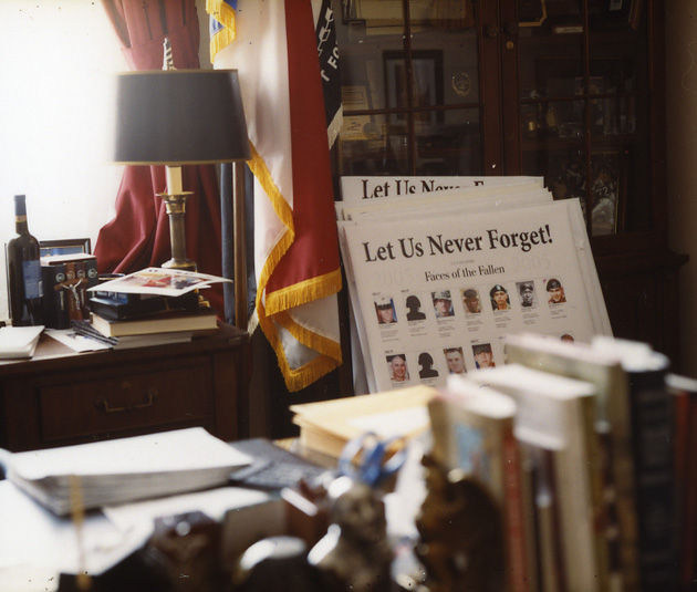 The "Faces of the Fallen" exhibit outside Jones' office has grown so large that extra posters are stored by his desk.